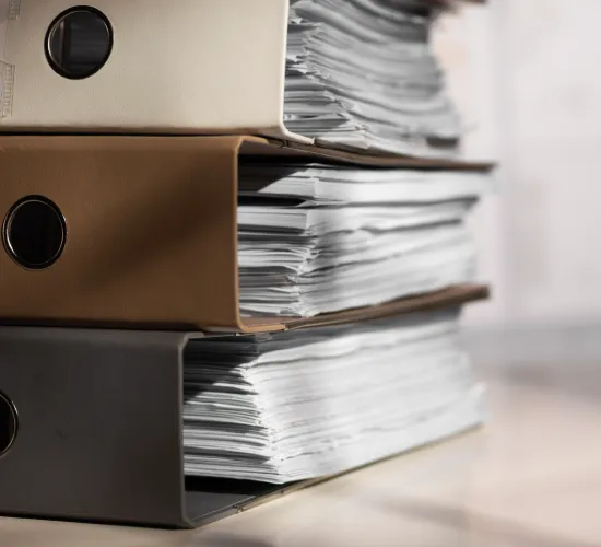 Tax documents, financial records, calculator, and notebook organized on a professional desk